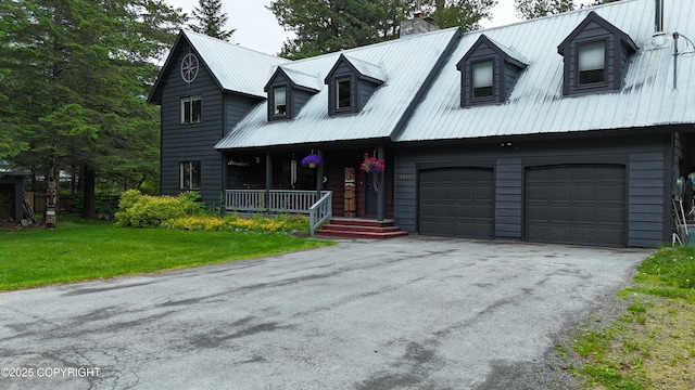 2600 Birch St, Seward, AK 99664 - view of front of home featuring a chimney, a porch, an attached garage, a metal roof, and a front yard