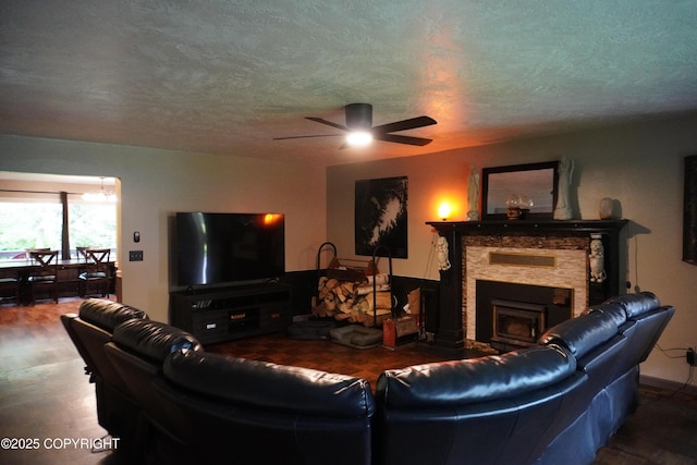 2600 Birch St, Seward, AK 99664 - living room with ceiling fan, a fireplace, and a textured ceiling