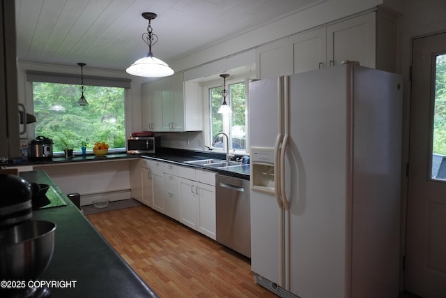 2600 Birch St, Seward, AK 99664 - kitchen featuring stainless steel appliances, white cabinetry, dark countertops, and plenty of natural light