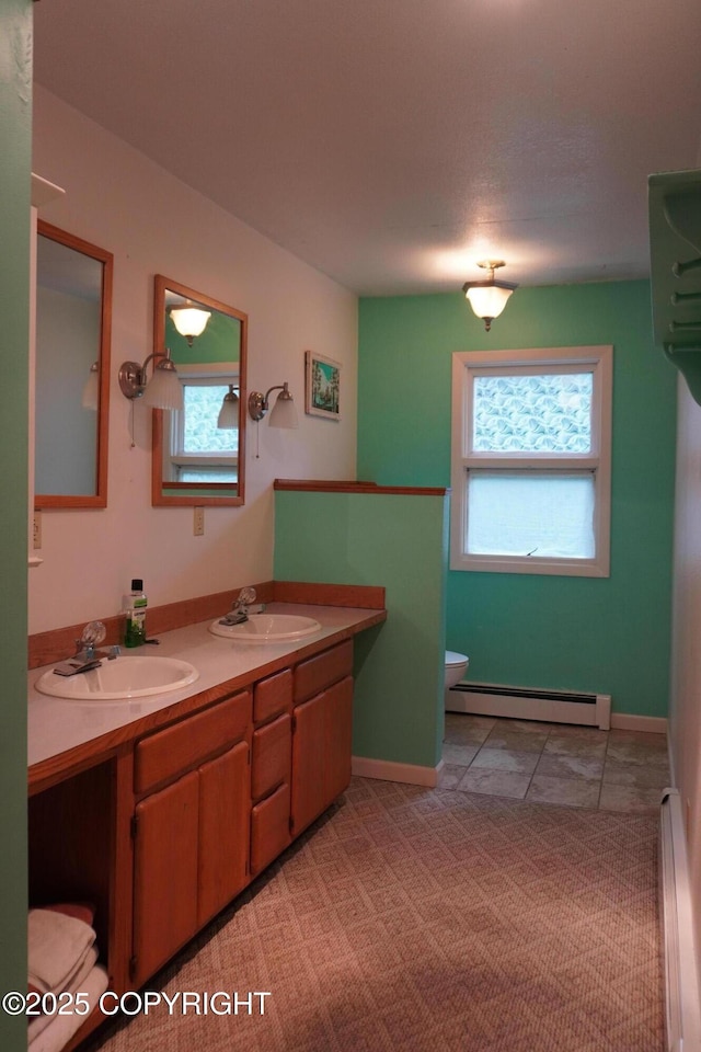 2600 Birch St, Seward, AK 99664 - bathroom with baseboard heating, double vanity, and tile patterned floors