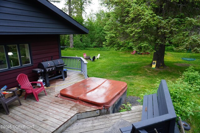 2600 Birch St, Seward, AK 99664 - wooden deck with area for grilling, a lawn, and a covered hot tub