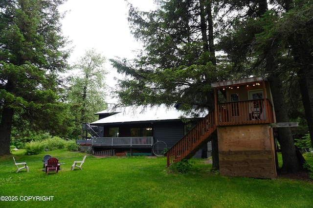 2600 Birch St, Seward, AK 99664 - back of property featuring a lawn, stairs, and a deck