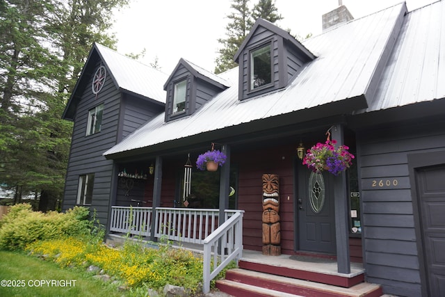 2600 Birch St, Seward, AK 99664 - view of front of property featuring covered porch, a chimney, and a metal roof