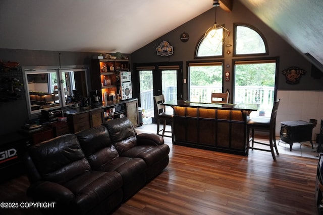 2600 Birch St, Seward, AK 99664 - living area with lofted ceiling, a bar, wood finished floors, and healthy amount of natural light
