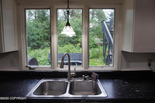 2600 Birch St, Seward, AK 99664 - kitchen view of dark countertops, white cabinetry, and pendant lighting