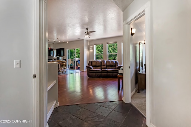 9700 E Strand Dr, Palmer, AK 99645 - hall featuring a textured ceiling and stone tile flooring