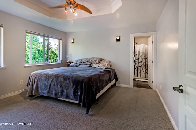9700 E Strand Dr, Palmer, AK 99645 - carpeted bedroom featuring a raised ceiling, ceiling fan, and ensuite bathroom