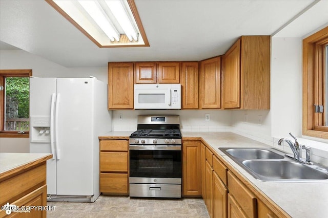 840 N Voss Cir, Wasilla, AK 99623 - kitchen with white appliances, light countertops, and brown cabinetry