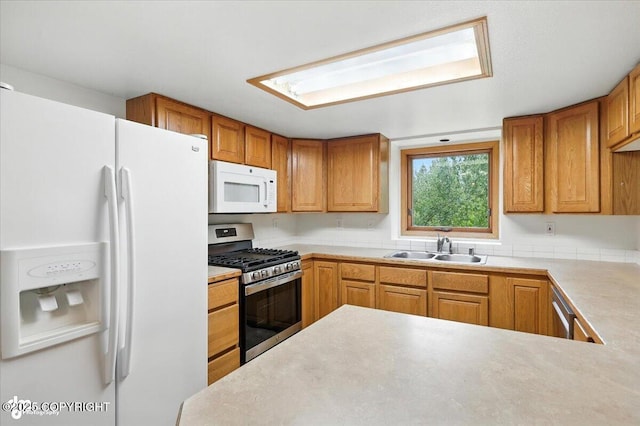 840 N Voss Cir, Wasilla, AK 99623 - kitchen with white appliances, light countertops, and brown cabinets