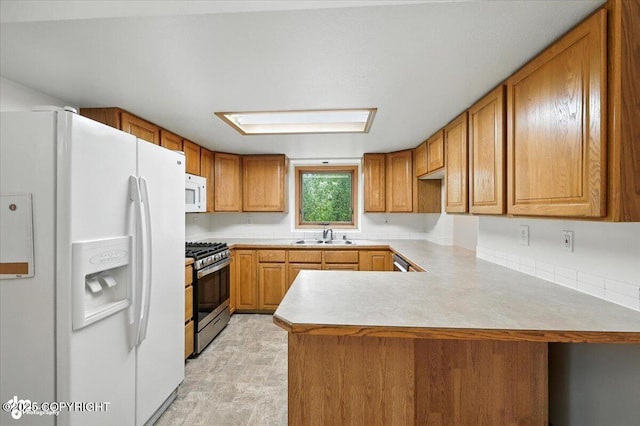 840 N Voss Cir, Wasilla, AK 99623 - kitchen with white appliances, a peninsula, brown cabinets, and light countertops