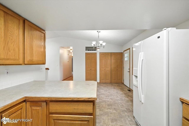 840 N Voss Cir, Wasilla, AK 99623 - kitchen featuring white fridge with ice dispenser, a chandelier, lofted ceiling, a peninsula, and brown cabinets