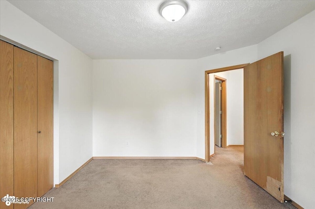 840 N Voss Cir, Wasilla, AK 99623 - unfurnished bedroom featuring light colored carpet, a textured ceiling, and a closet