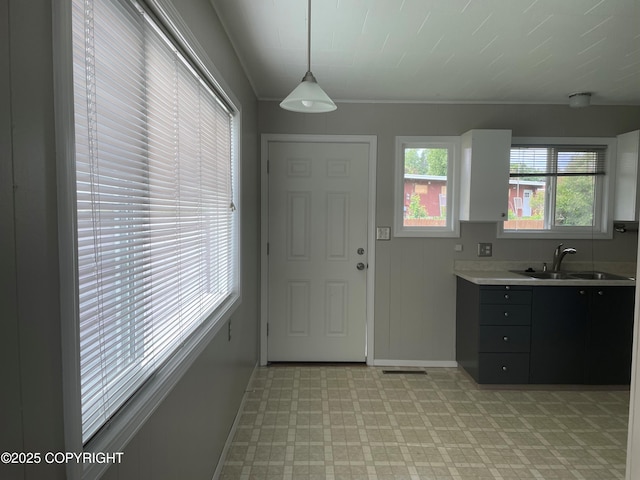 634 W 18th Ave, Anchorage, AK 99503 - kitchen with light countertops, light flooring, and pendant lighting