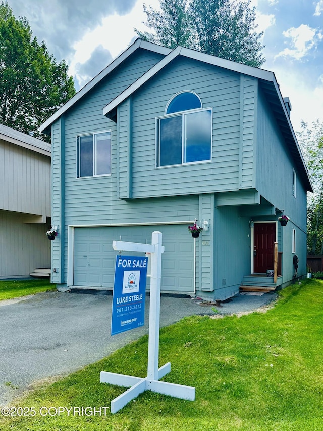1914 Sturbridge Ct, Anchorage, AK 99507 - view of front of home with an attached garage, a front yard, and asphalt driveway