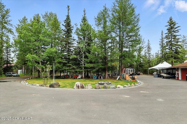 35485 Bluff Ct, Sterling, AK 99672 - view of property hidden behind natural elements featuring a front yard and view of wooded area