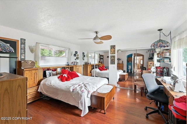 35485 Bluff Ct, Sterling, AK 99672 - bedroom featuring wood finished floors, a textured ceiling, an office area, and ceiling fan