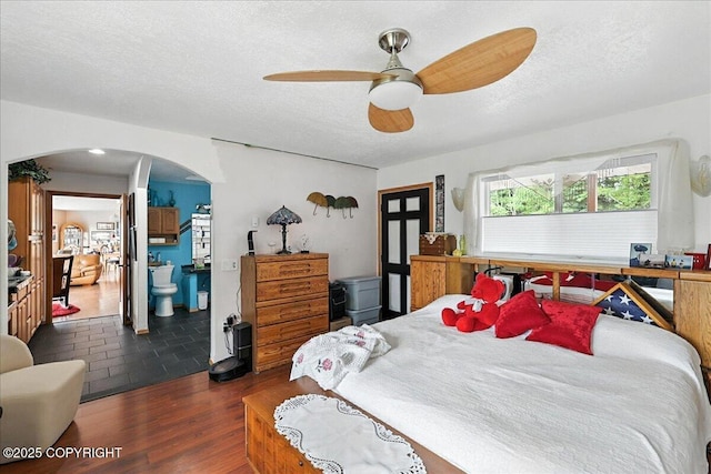 35485 Bluff Ct, Sterling, AK 99672 - bedroom with arched walkways, wood finished floors, a textured ceiling, and ceiling fan