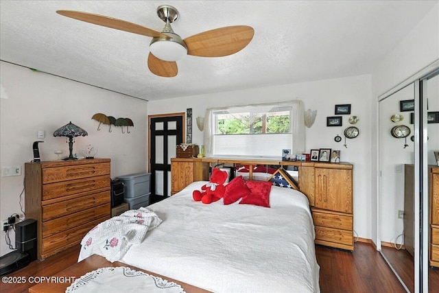 35485 Bluff Ct, Sterling, AK 99672 - bedroom with dark wood finished floors, a ceiling fan, and a textured ceiling