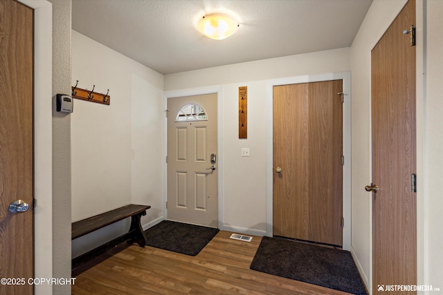 5170 Merle Cir, Anchorage, AK 99507 - entrance foyer featuring wood finished floors and baseboards
