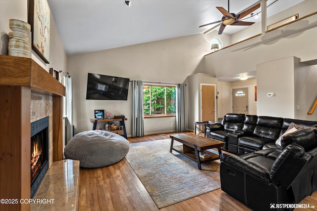 5170 Merle Cir, Anchorage, AK 99507 - living area with ceiling fan, high vaulted ceiling, wood finished floors, and a fireplace
