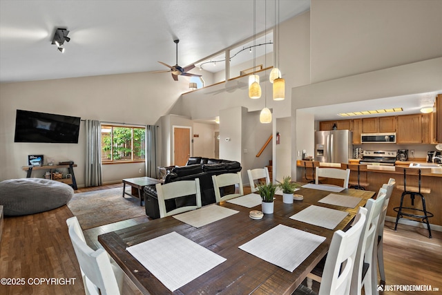 5170 Merle Cir, Anchorage, AK 99507 - dining space featuring a ceiling fan, wood finished floors, and high vaulted ceiling