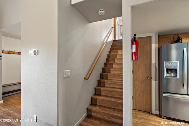 5170 Merle Cir, Anchorage, AK 99507 - stairway featuring wood finished floors and a textured wall