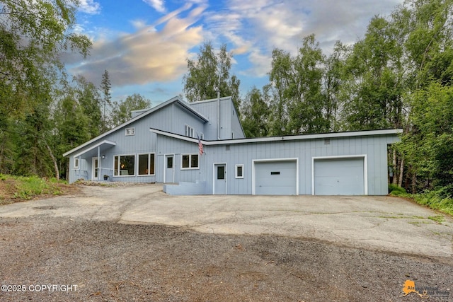 9601 Carlson Rd, Anchorage, AK 99507 - view of front of home with driveway, a garage, and board and batten siding