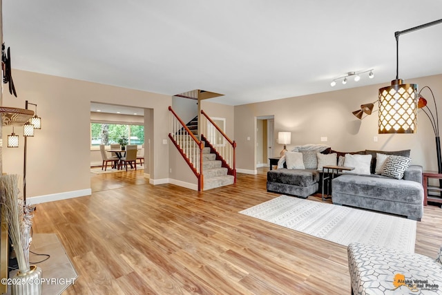 9601 Carlson Rd, Anchorage, AK 99507 - living room featuring stairs and light wood-style floors