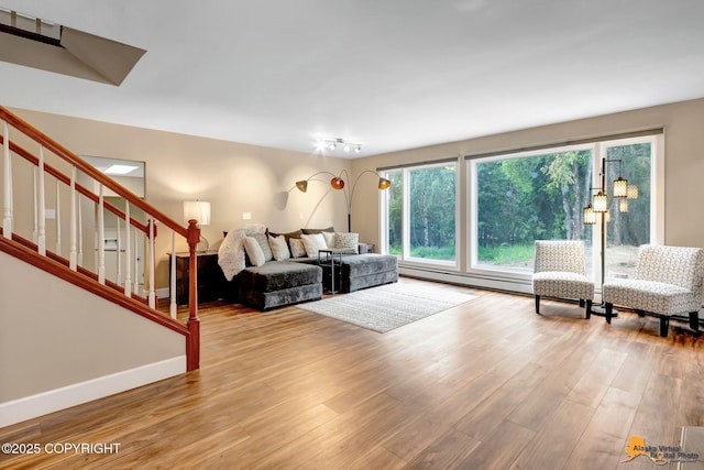 9601 Carlson Rd, Anchorage, AK 99507 - living area featuring wood finished floors, stairs, and baseboard heating
