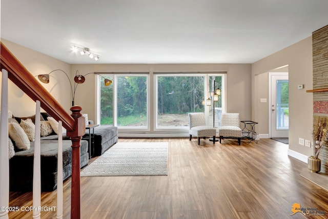 9601 Carlson Rd, Anchorage, AK 99507 - living room featuring wood finished floors, plenty of natural light, and baseboard heating