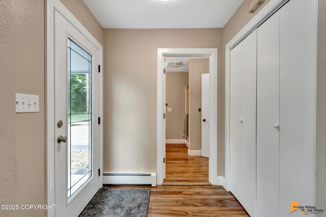 9601 Carlson Rd, Anchorage, AK 99507 - entrance foyer featuring baseboard heating, healthy amount of natural light, and light wood-type flooring