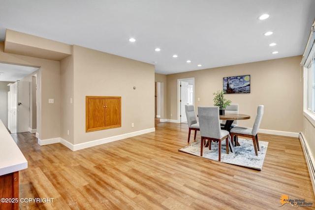 9601 Carlson Rd, Anchorage, AK 99507 - dining area with recessed lighting, light wood finished floors, and a baseboard radiator