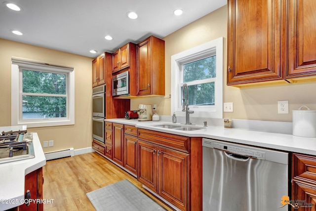 9601 Carlson Rd, Anchorage, AK 99507 - kitchen with stainless steel appliances, light countertops, a baseboard heating unit, and recessed lighting