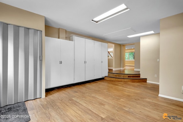 9601 Carlson Rd, Anchorage, AK 99507 - below grade area with light wood-style flooring and baseboards