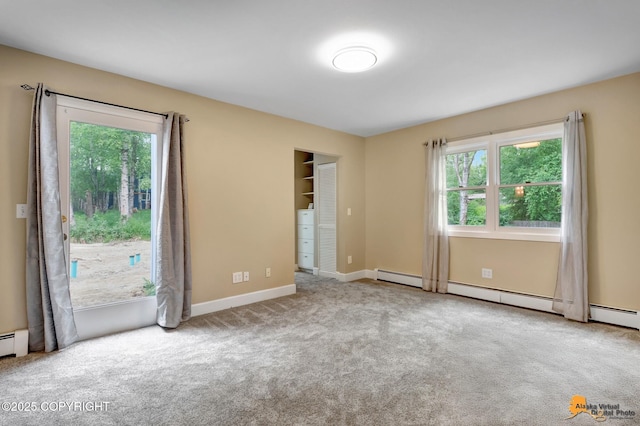 9601 Carlson Rd, Anchorage, AK 99507 - empty room with carpet floors and a baseboard heating unit