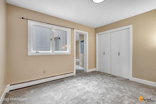 9601 Carlson Rd, Anchorage, AK 99507 - unfurnished bedroom featuring a baseboard radiator, carpet flooring, and a closet
