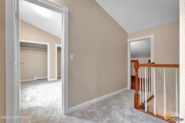 9601 Carlson Rd, Anchorage, AK 99507 - hallway with vaulted ceiling, an upstairs landing, carpet floors, and a baseboard radiator