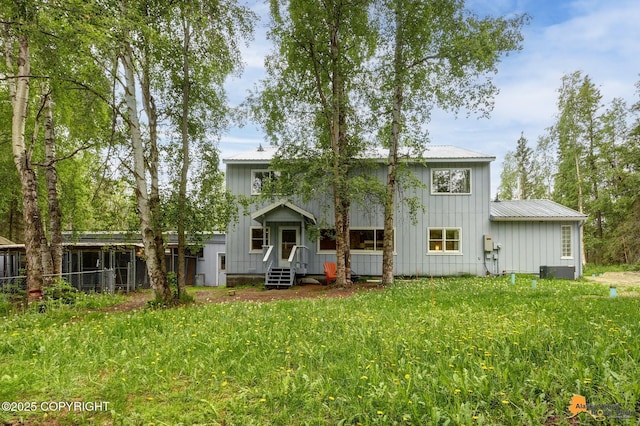 9601 Carlson Rd, Anchorage, AK 99507 - rear view of house with a metal roof and board and batten siding