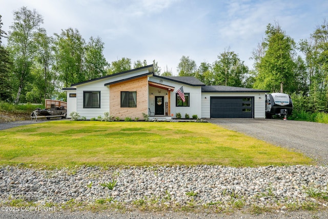 3200 E Woodruff Loop, Wasilla, AK 99654 - view of front of house with an attached garage, asphalt driveway, and a front yard
