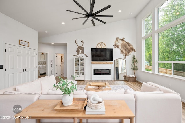 3200 E Woodruff Loop, Wasilla, AK 99654 - living room with healthy amount of natural light, vaulted ceiling, a ceiling fan, recessed lighting, and light wood-style flooring