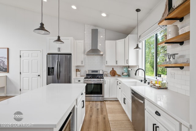 3200 E Woodruff Loop, Wasilla, AK 99654 - kitchen with stainless steel appliances, wall chimney range hood, lofted ceiling, open shelves, and decorative backsplash