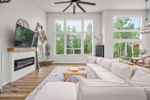3200 E Woodruff Loop, Wasilla, AK 99654 - living room featuring a chandelier, a ceiling fan, plenty of natural light, and wood finished floors