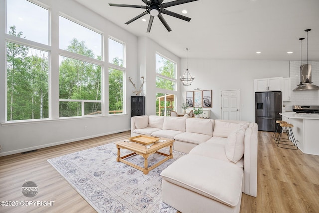 3200 E Woodruff Loop, Wasilla, AK 99654 - living room with ceiling fan, recessed lighting, light wood-style flooring, and a chandelier