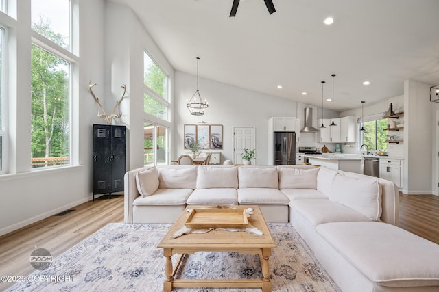 3200 E Woodruff Loop, Wasilla, AK 99654 - living room with light wood-style floors, a chandelier, vaulted ceiling, recessed lighting, and a ceiling fan