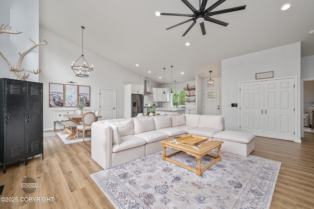 3200 E Woodruff Loop, Wasilla, AK 99654 - living area with ceiling fan, light wood-style flooring, a chandelier, recessed lighting, and high vaulted ceiling