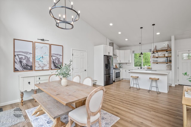 3200 E Woodruff Loop, Wasilla, AK 99654 - dining space featuring a chandelier, light wood-style flooring, high vaulted ceiling, and recessed lighting