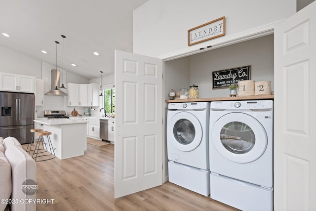 3200 E Woodruff Loop, Wasilla, AK 99654 - laundry area featuring washing machine and dryer, light wood-style flooring, and recessed lighting
