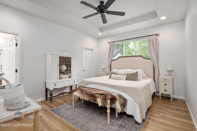 3200 E Woodruff Loop, Wasilla, AK 99654 - bedroom with light wood-style flooring, recessed lighting, a tray ceiling, and a ceiling fan