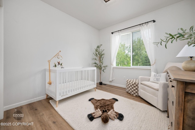 3200 E Woodruff Loop, Wasilla, AK 99654 - bedroom featuring wood finished floors, a crib, and lofted ceiling