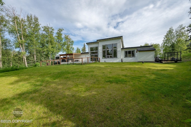 3200 E Woodruff Loop, Wasilla, AK 99654 - back of property featuring a lawn, stucco siding, and a wooden deck